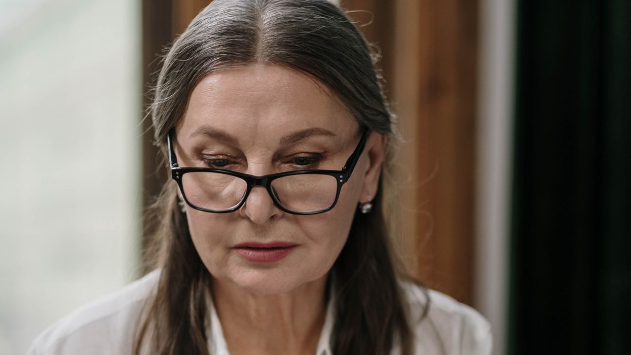 Woman looking at laptop looking serious
