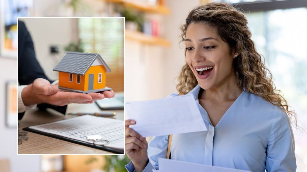Woman looking at letter and little house