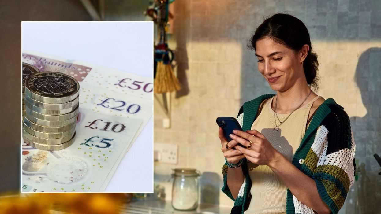 Woman looking at phone and British pounds