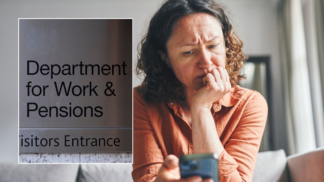 Woman looking at phone and DWP sign