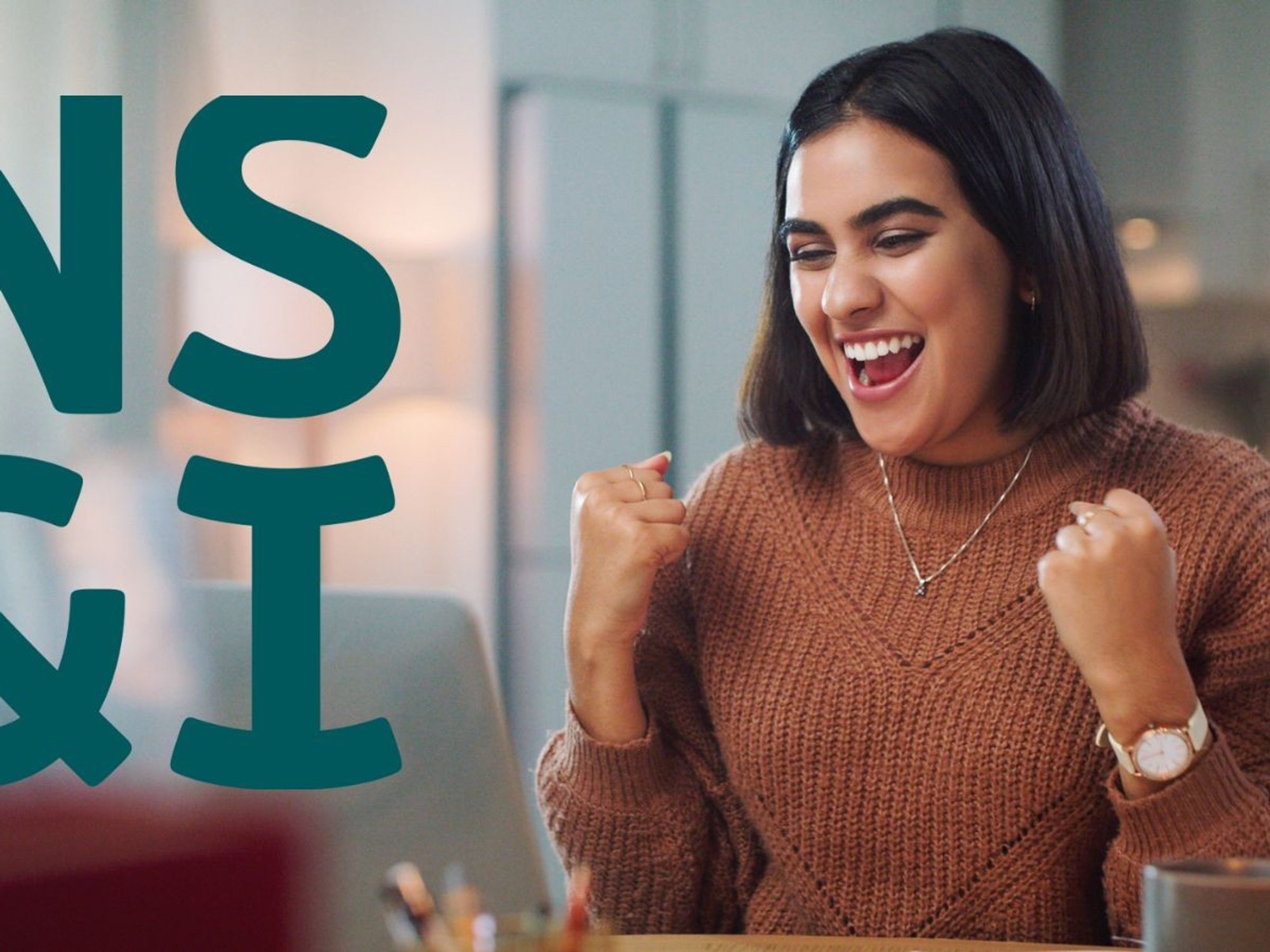 Woman looking happy at laptop and NS&I logo