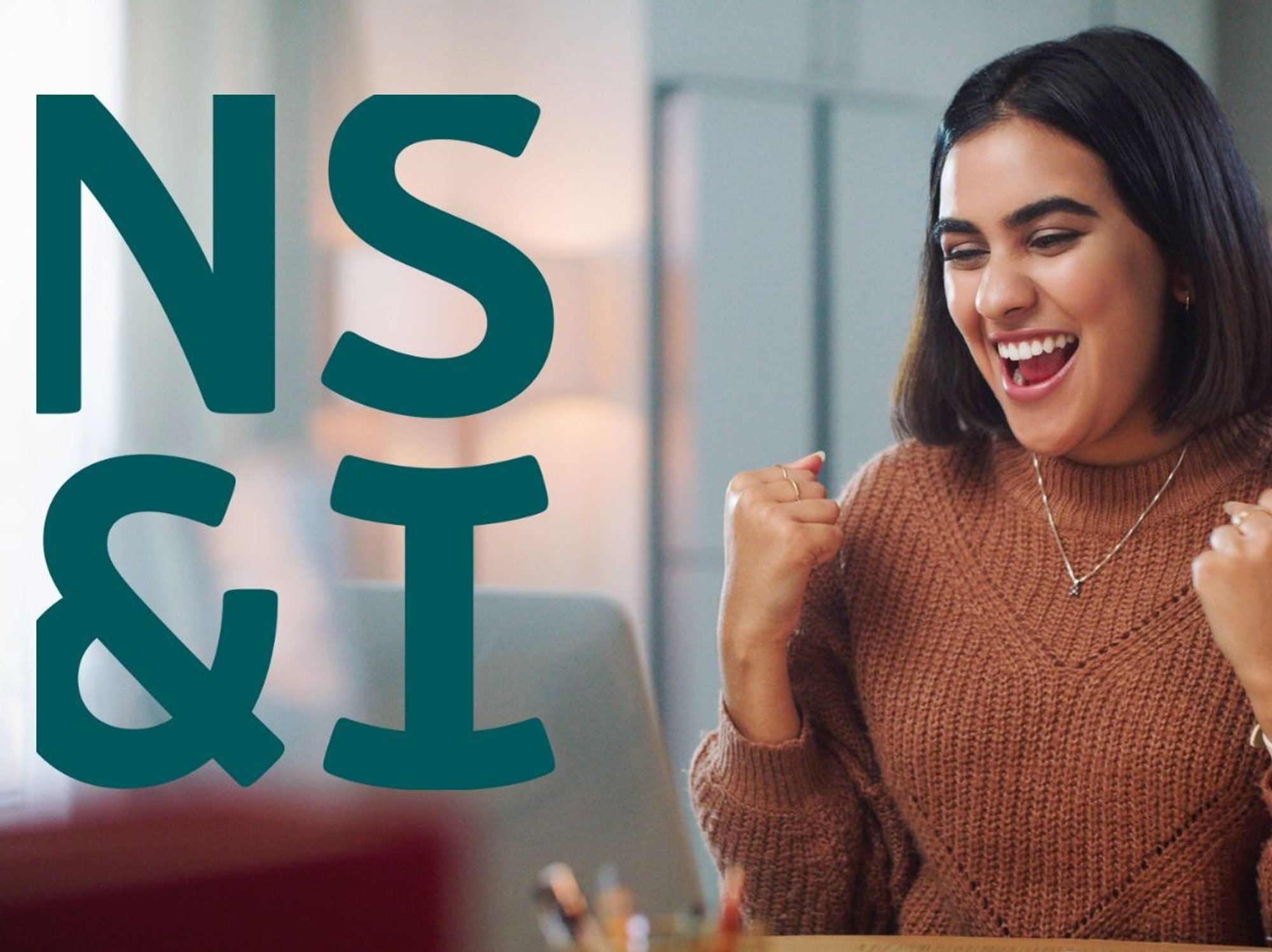 Woman looking happy at laptop and NS&I logo