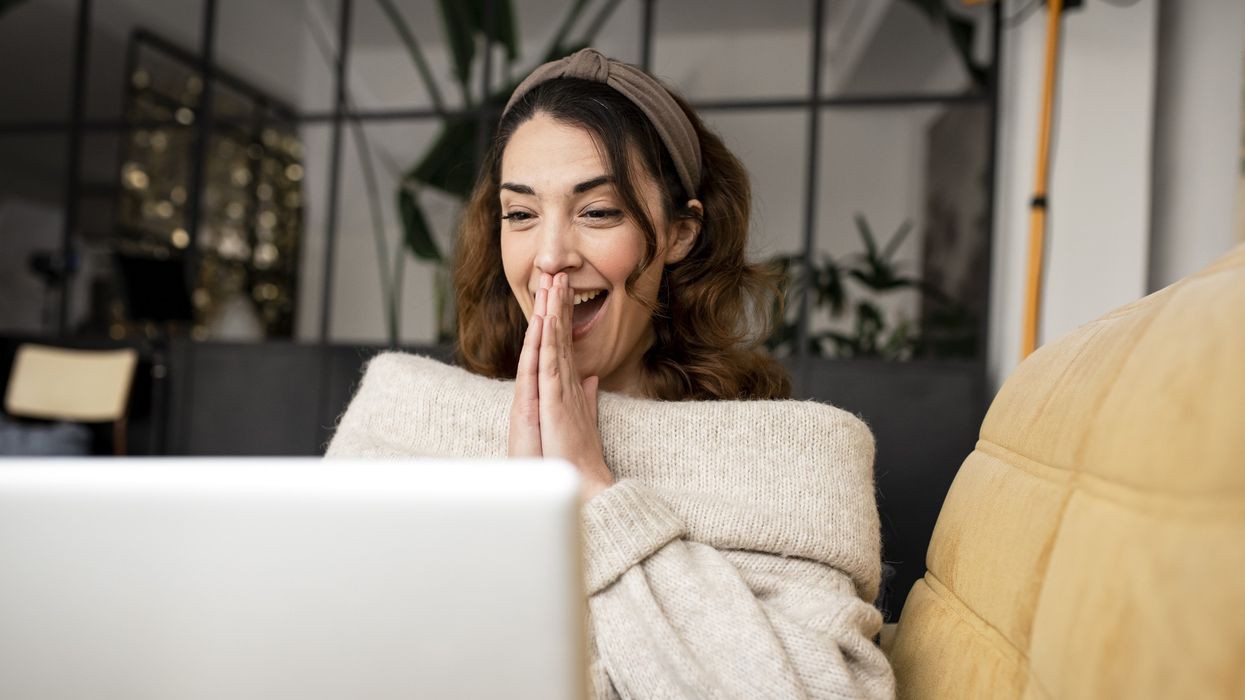 Woman looking happy at laptop