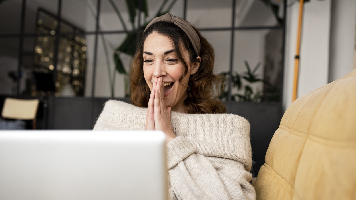 Woman looking happy at laptop