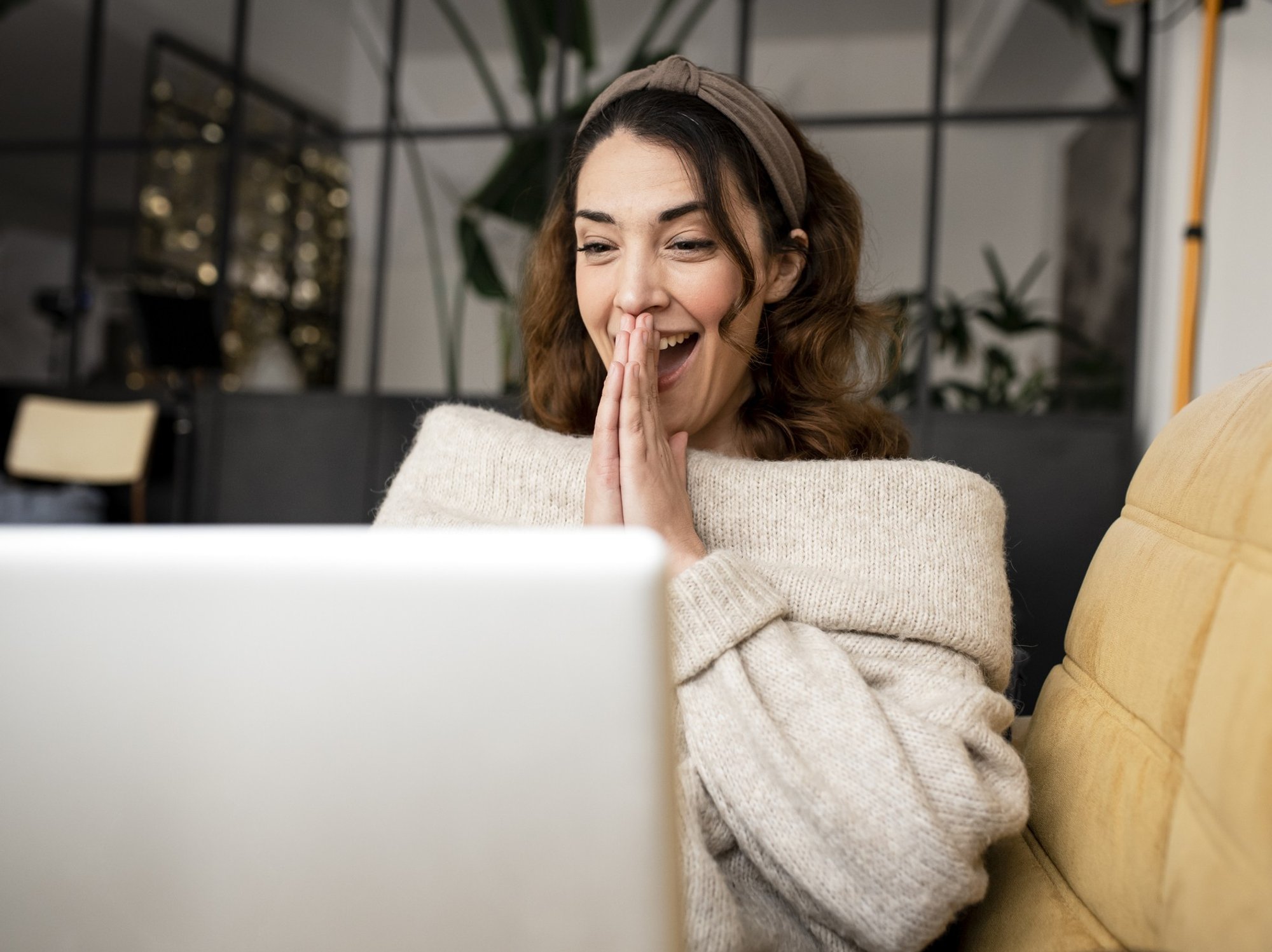 Woman looking happy at laptop