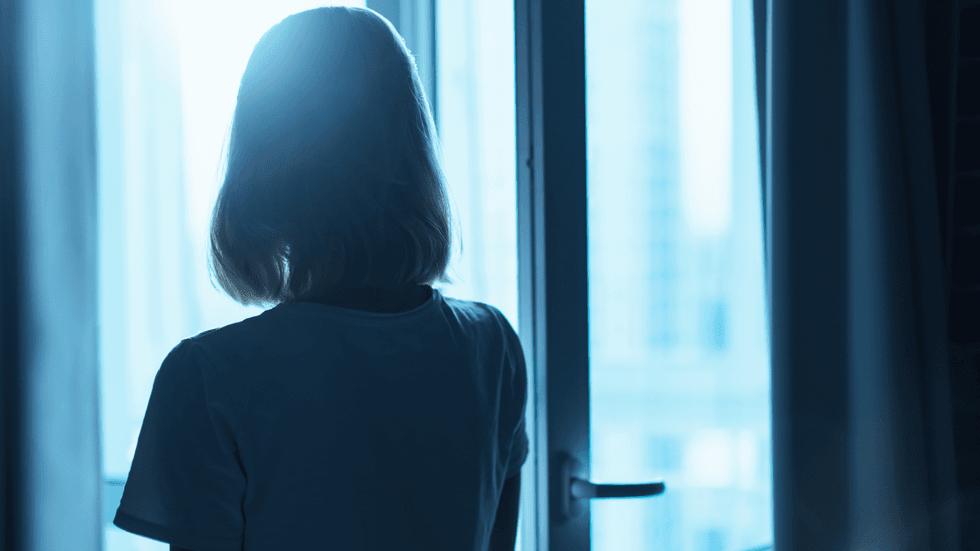 Woman looking out of window