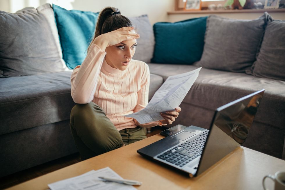 Woman looking shocked at financial statement