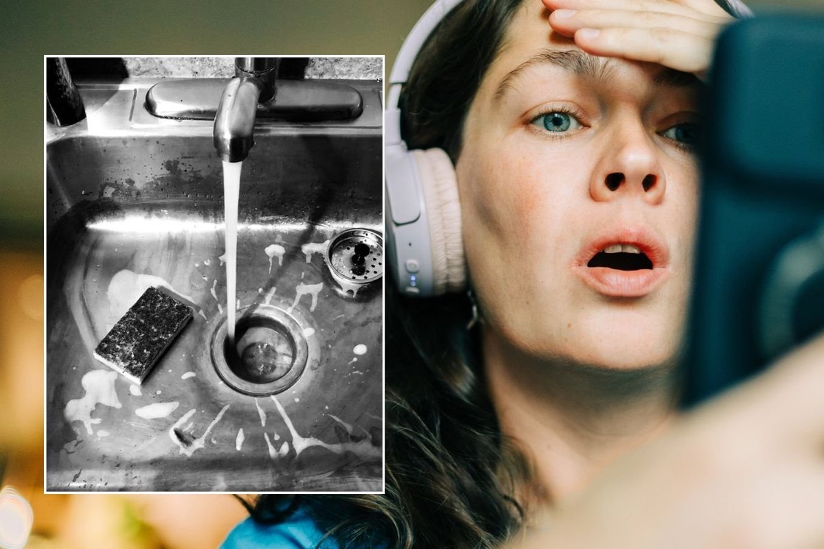 Woman looking shocked at phone, water running from tap