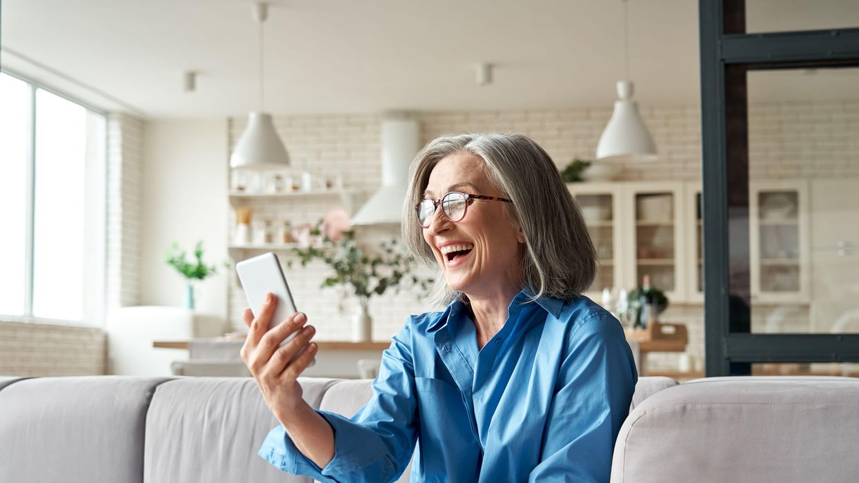 Woman looking very happy while looking at phone