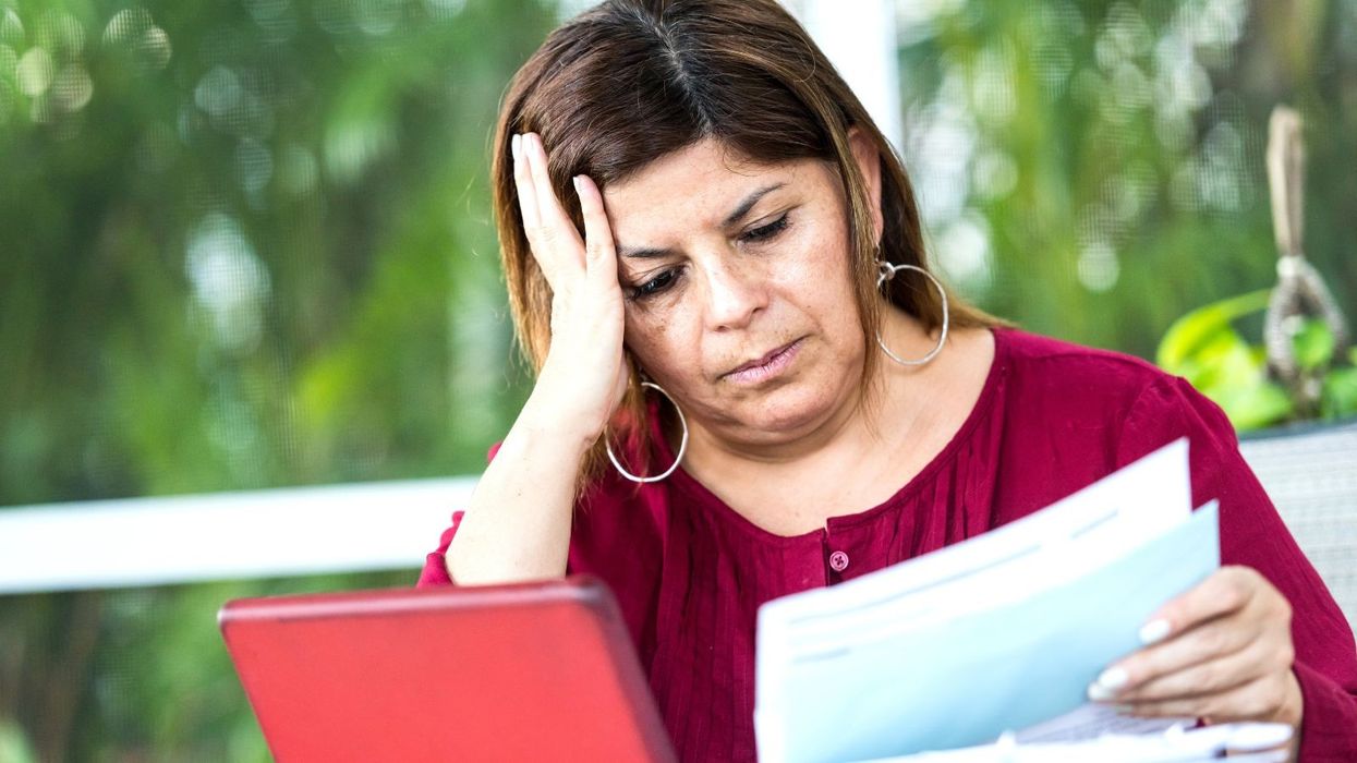 Woman looking worried at documents