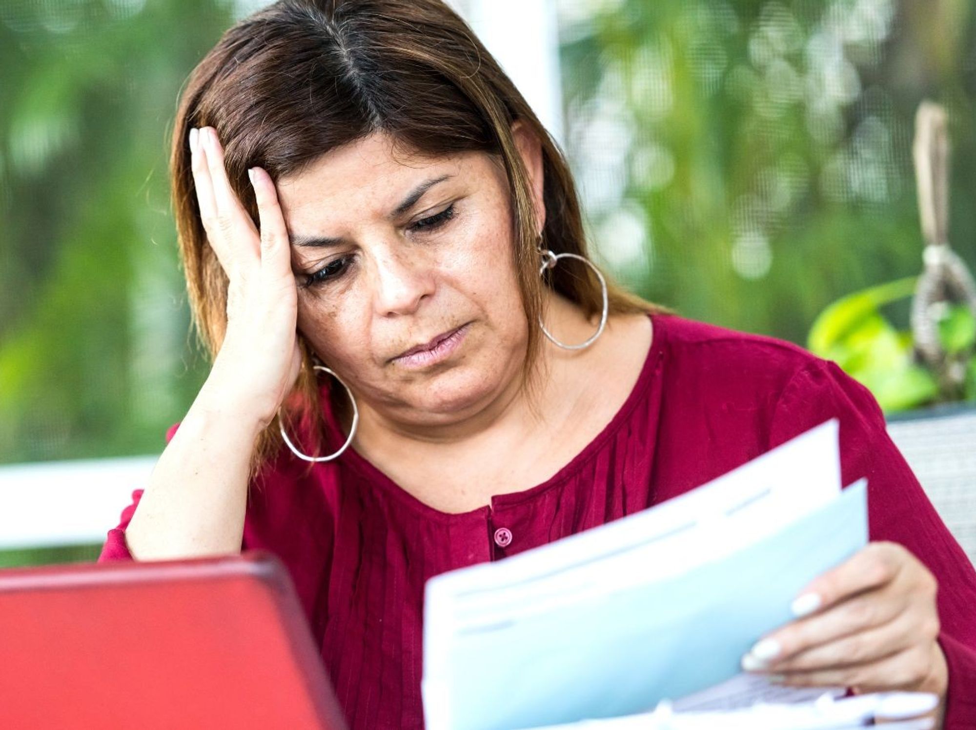 Woman looking worried at documents