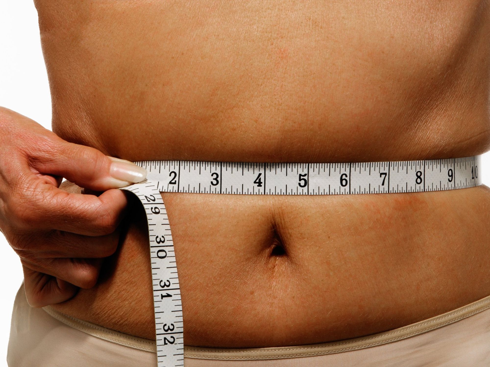 Woman measuring her waist