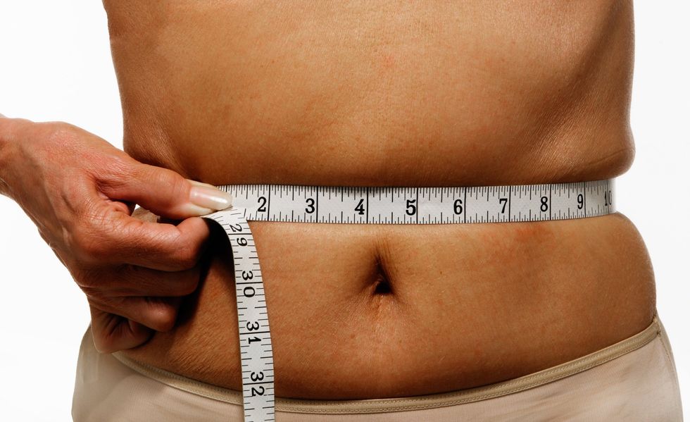 Woman measuring her waist