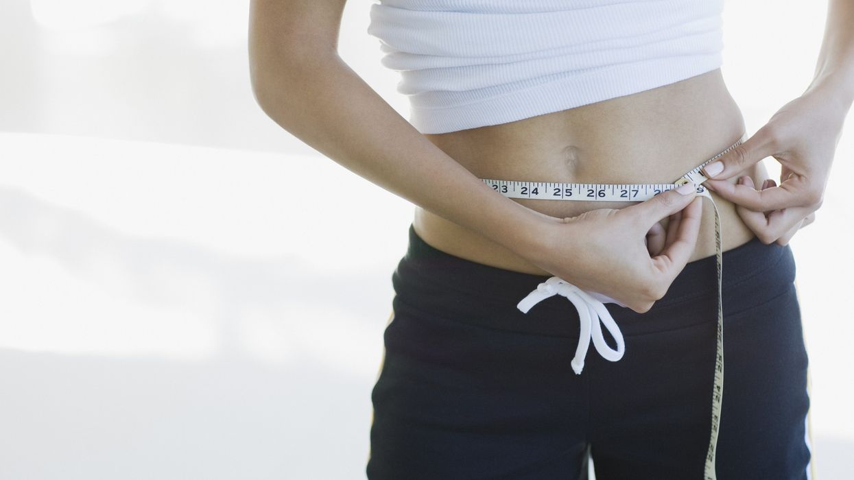 woman measuring waist