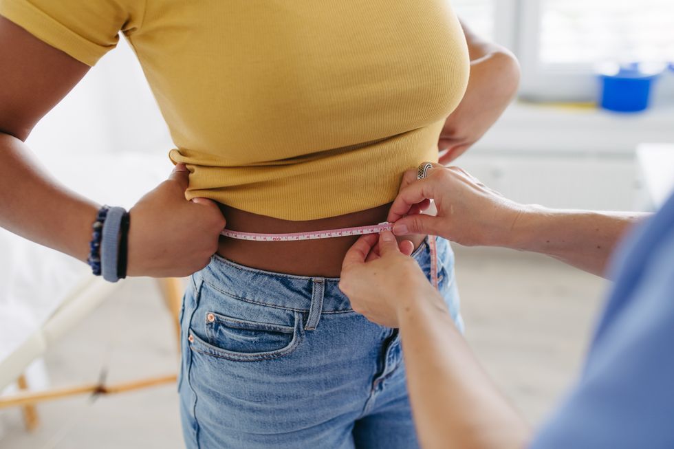 woman measuring waist