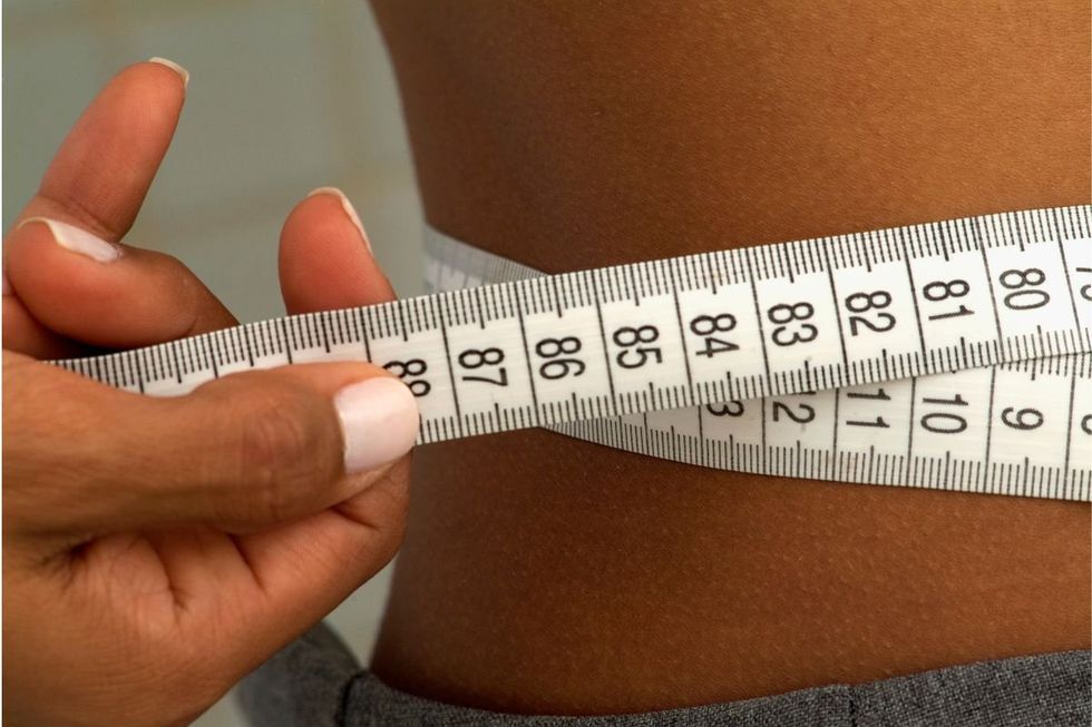 WOMAN MEASURING WAIST