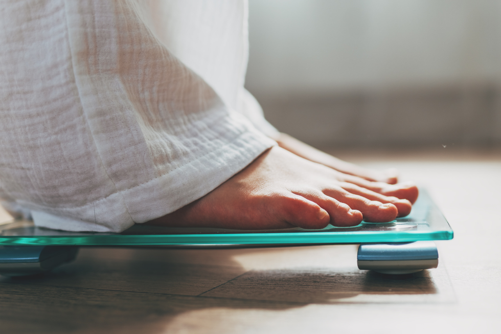 Woman on bathroom scales