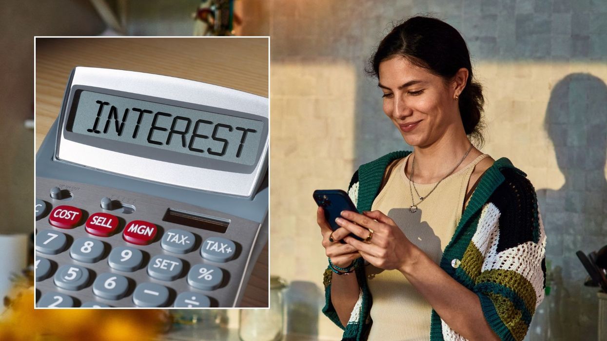 Woman on phone and interest rate on calculator