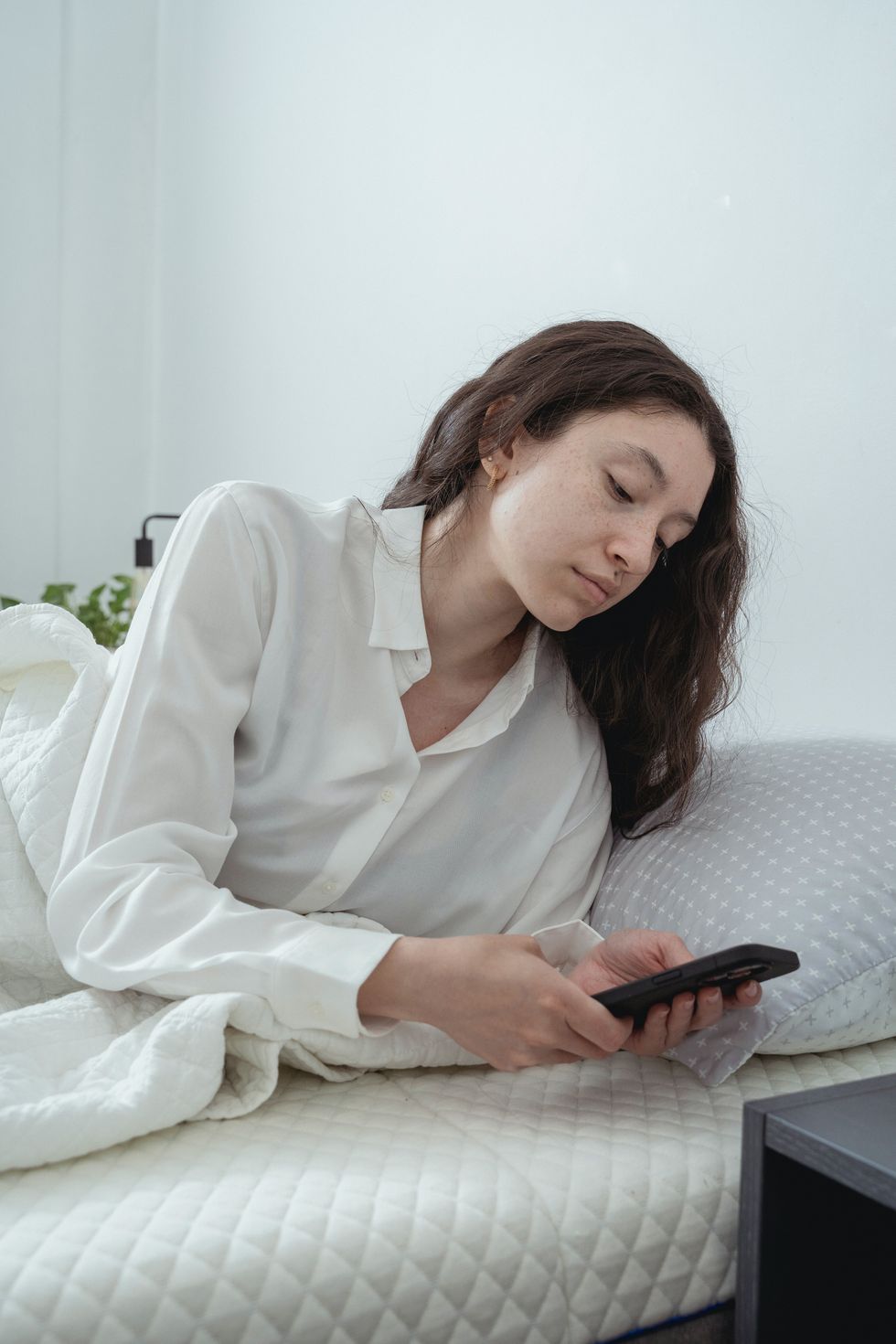 Woman on phone in bed