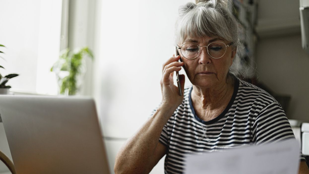 Woman on the phone looking at document