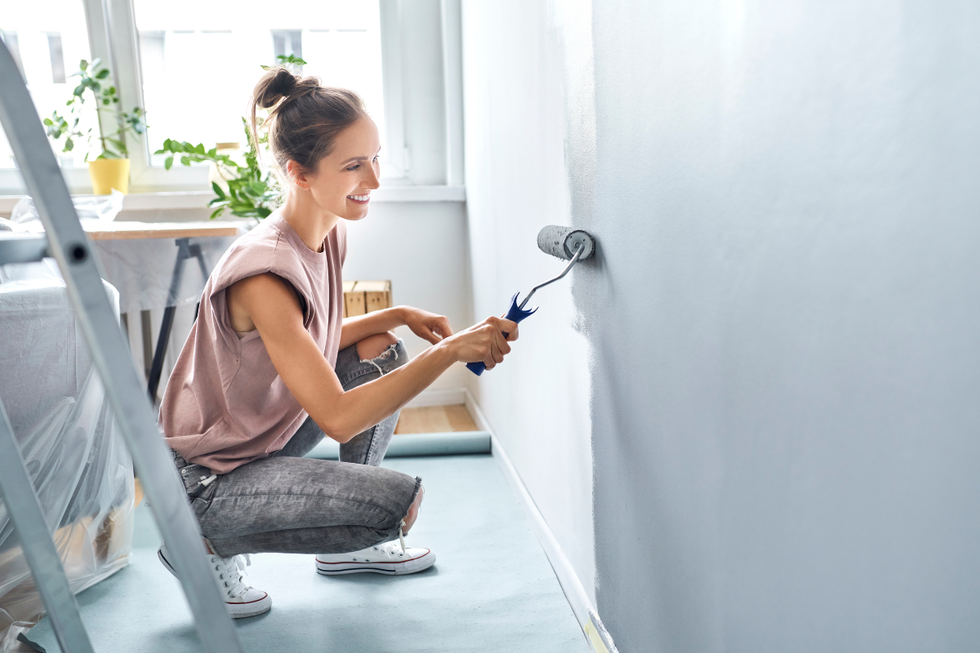 Woman painting a wall