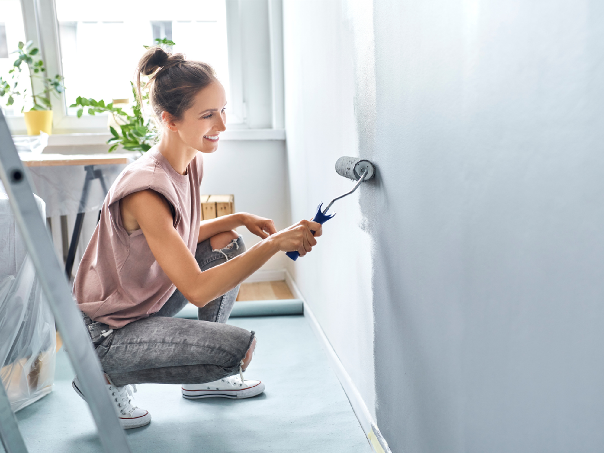 Woman painting a wall