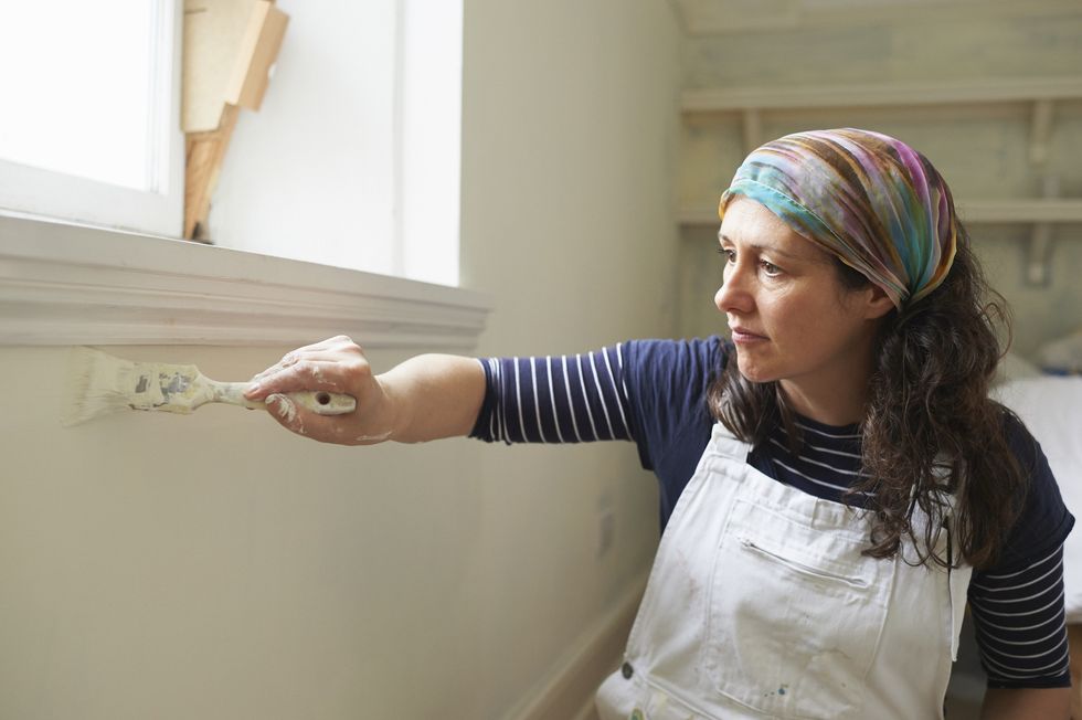 Woman painting walls white