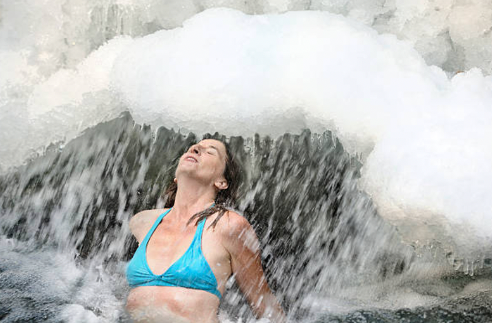 Woman plunging into ice cold water