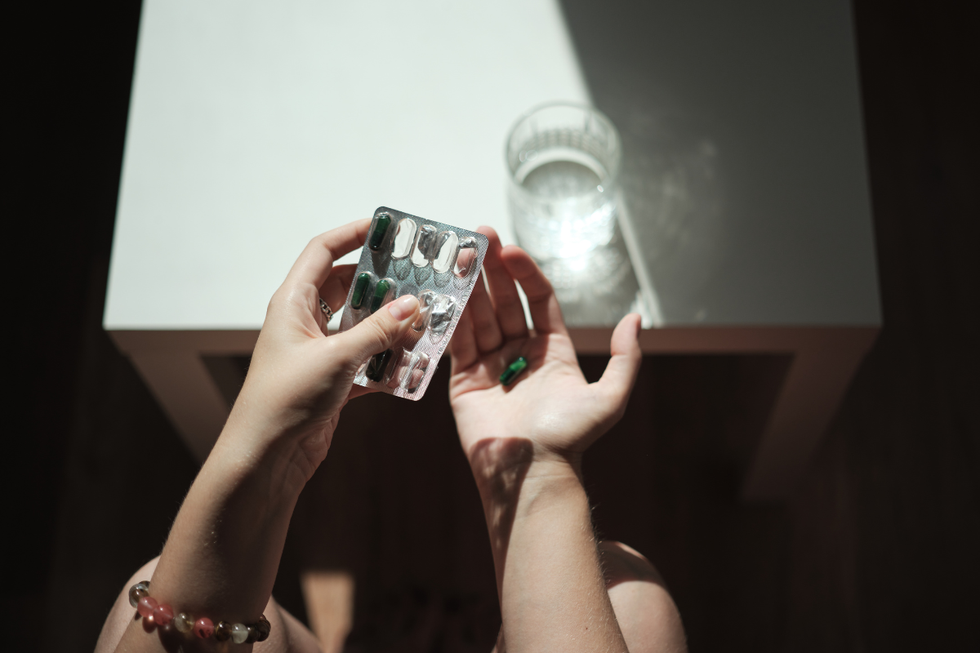 Woman popping an antidepressant pill