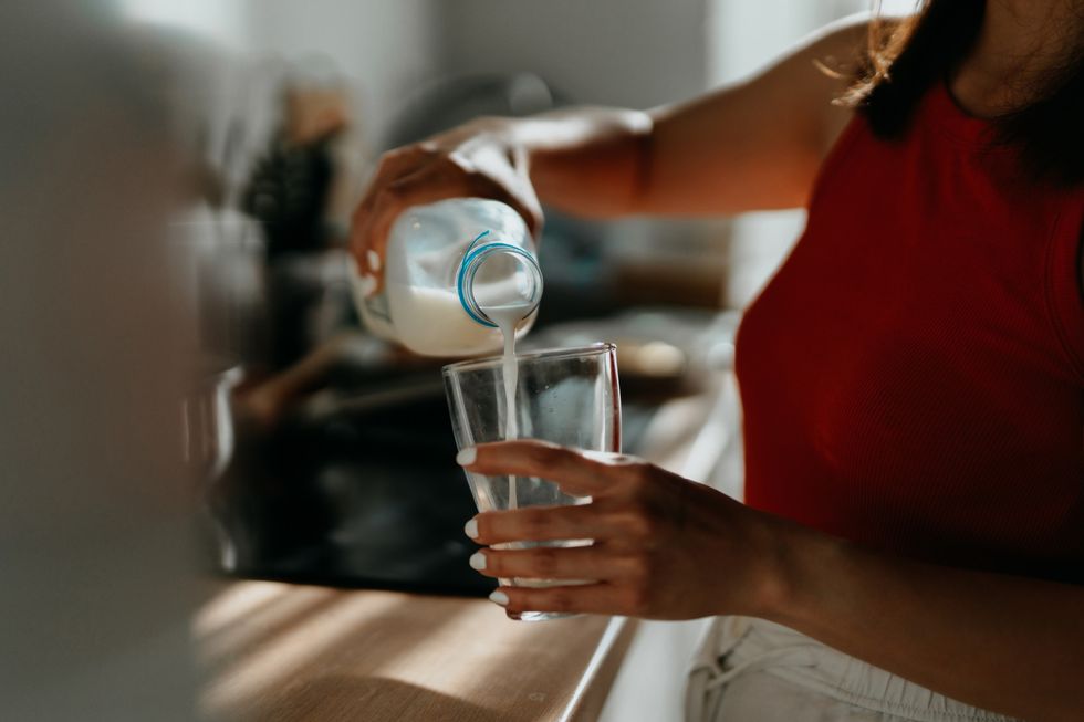 Woman pouring a glass of milk