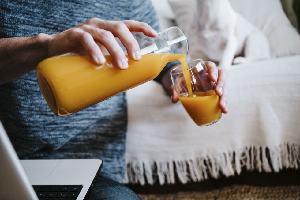 Woman pouring fruit juice