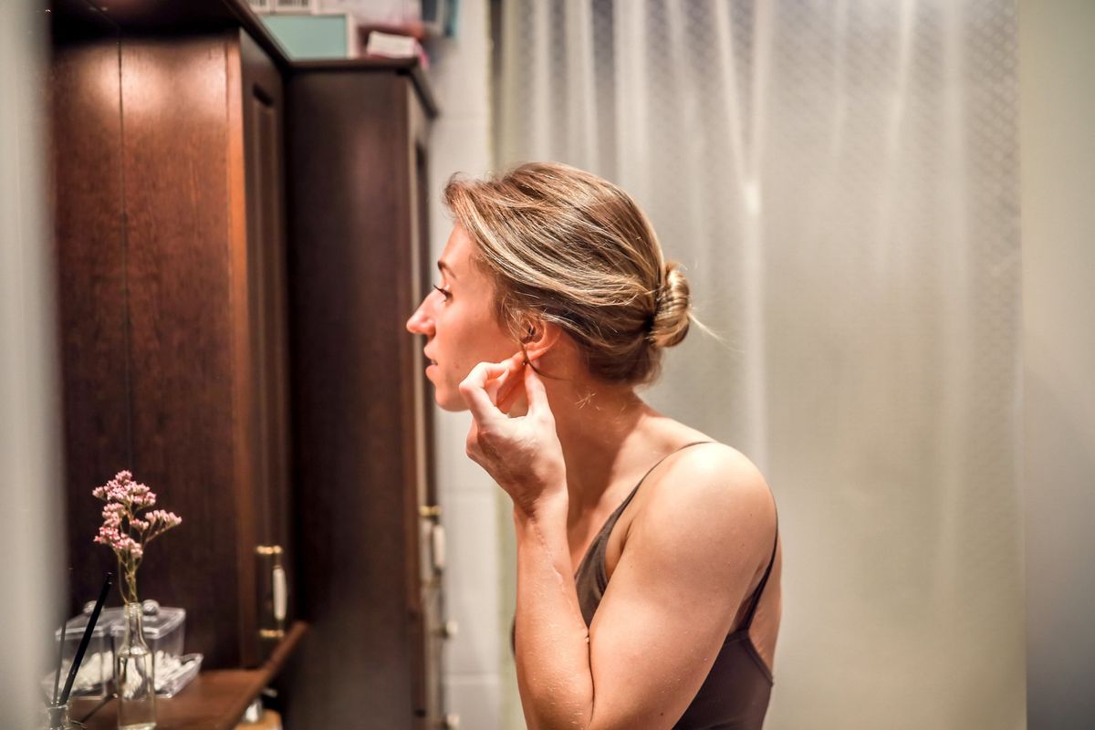 Woman puting in earrings