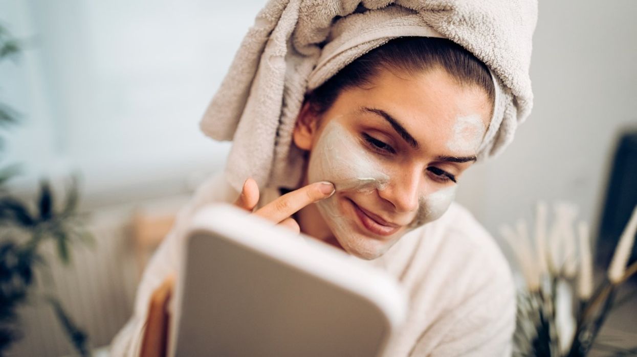 Woman putting on face mask