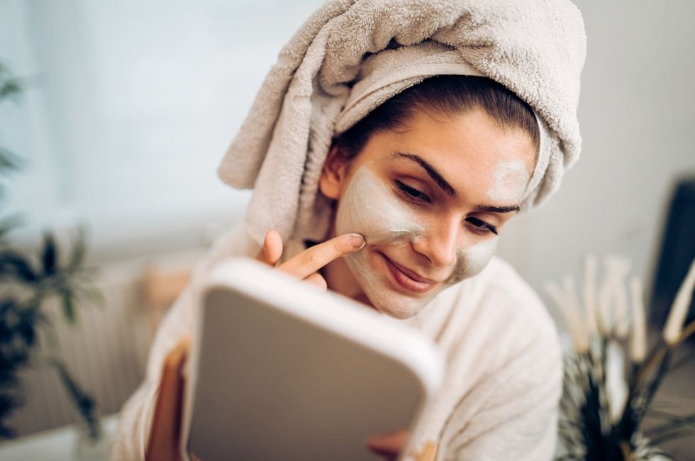 Woman putting on face mask