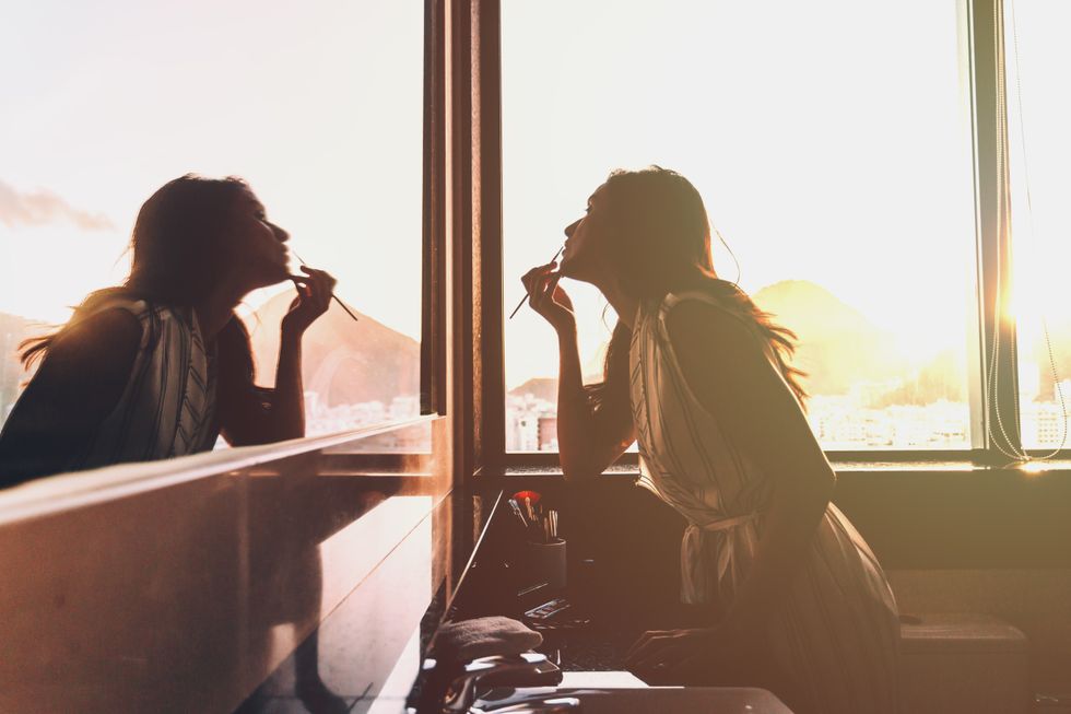 Woman putting on make up