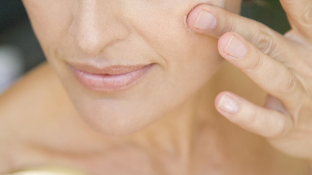 Woman putting on moisturiser