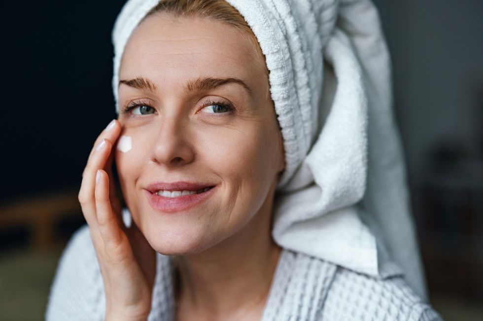 Woman putting on skin care