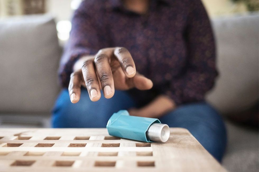 woman reaching for inhaler