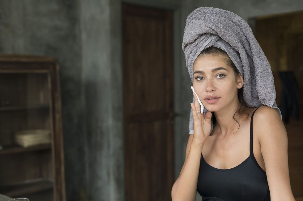 Woman removing makeup with wipe