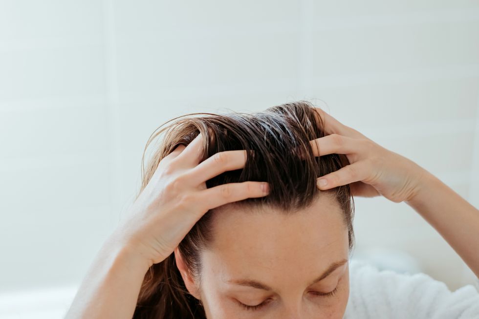 Woman rubbing her scalp