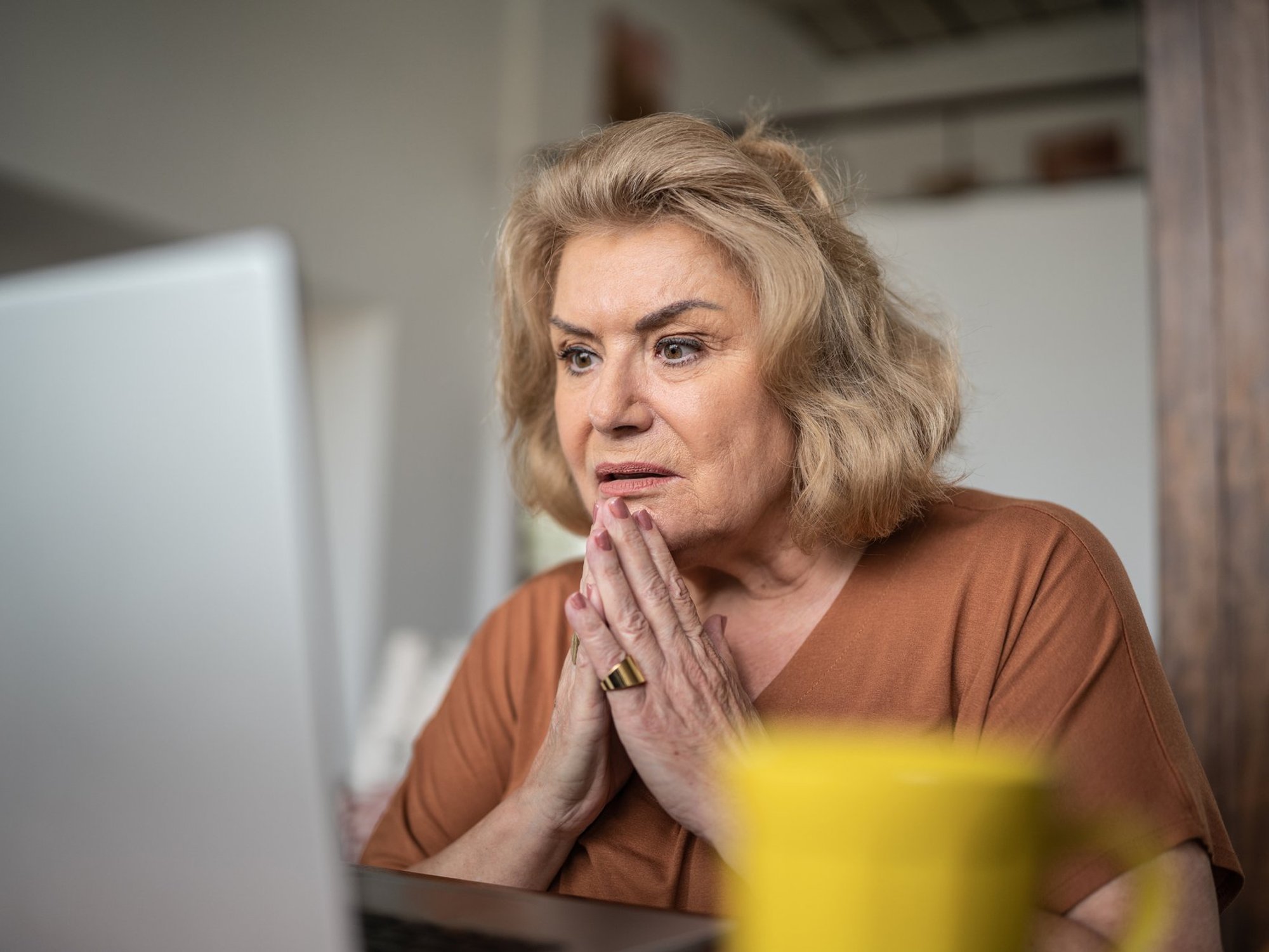 Woman shocked at laptop