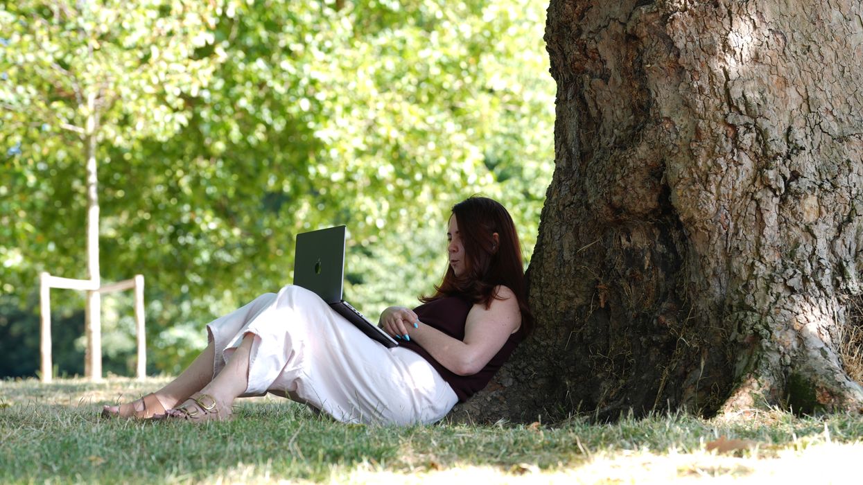 Woman sits under tree