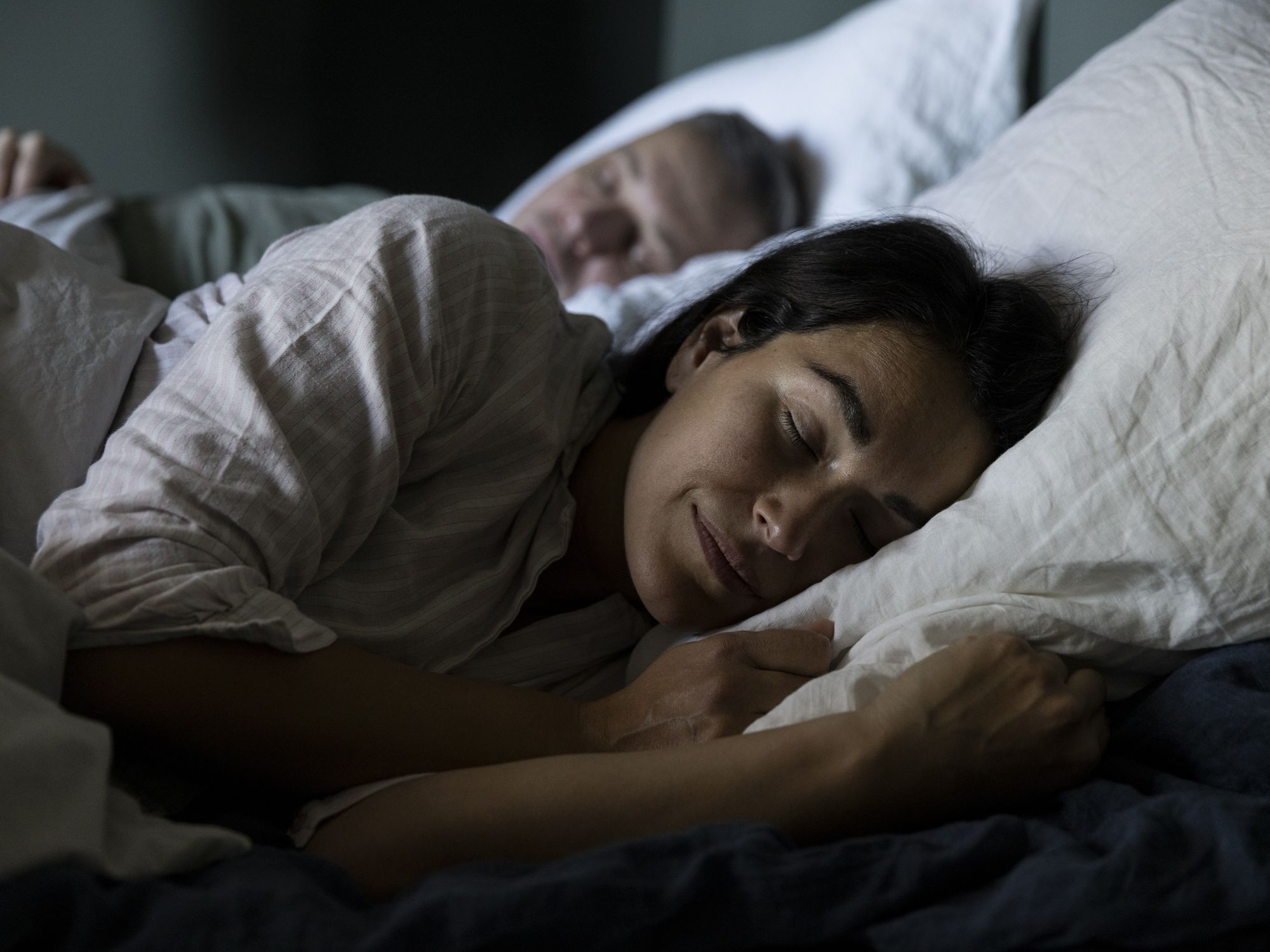 woman sleeping next to partner