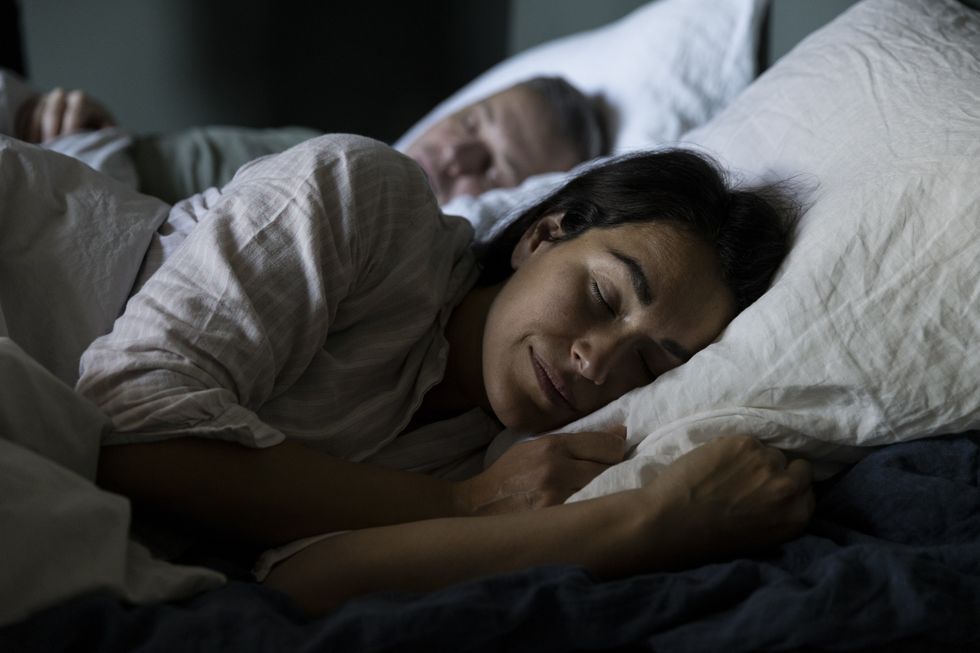 woman sleeping next to partner