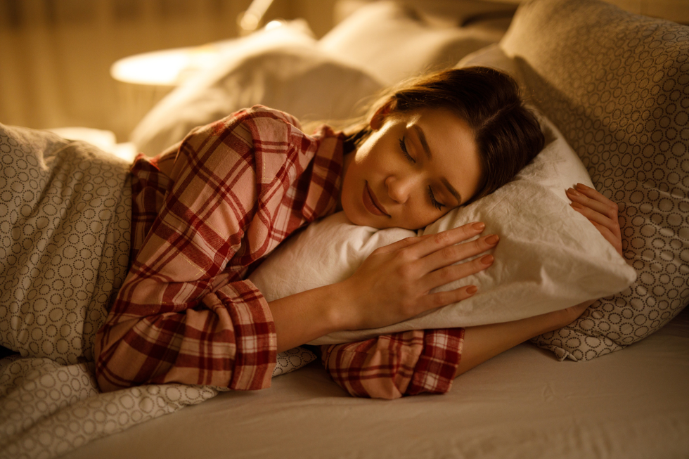 Woman sleeping on her side in a bed