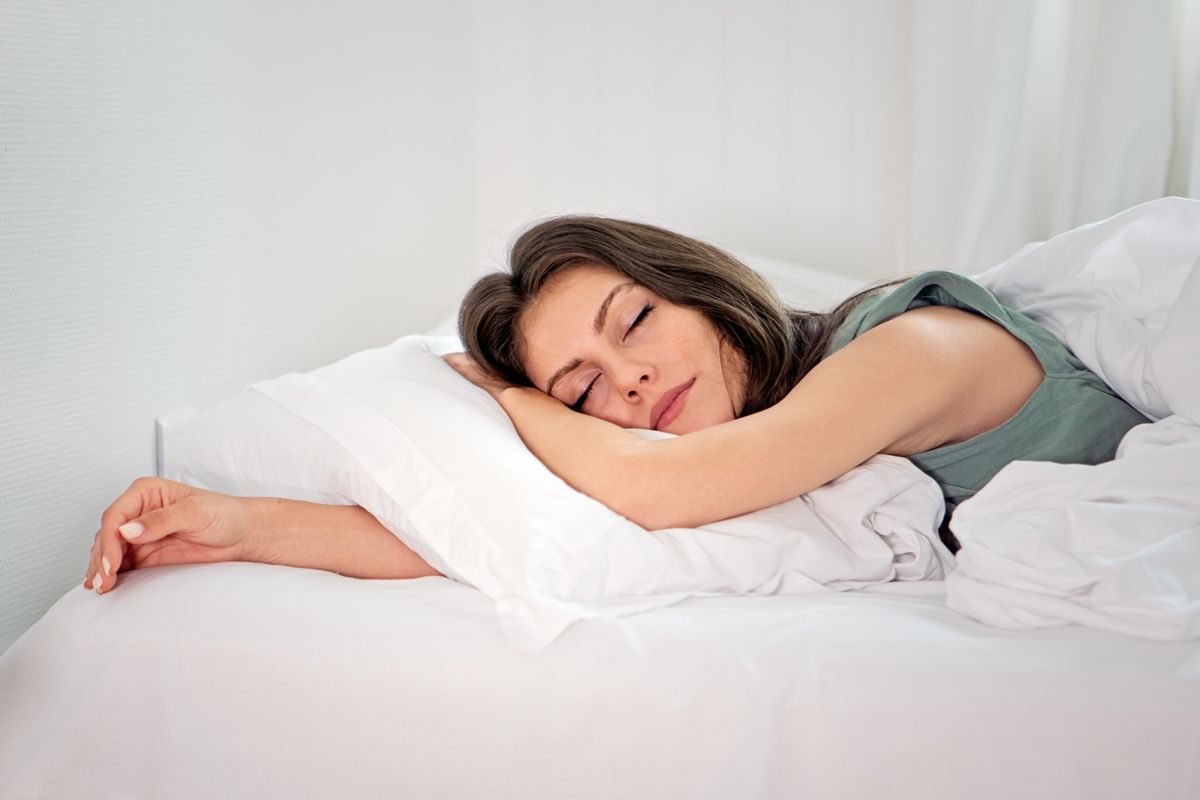 Woman sleeping on mattress topper
