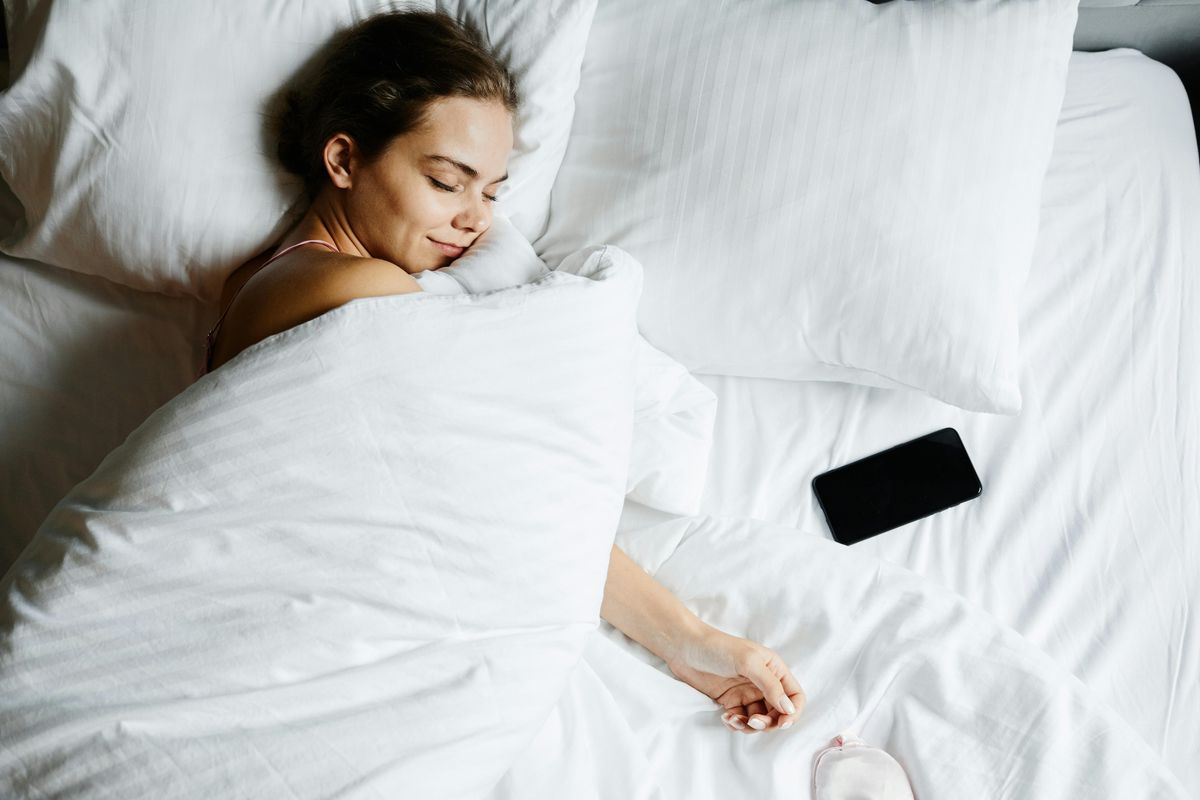 Woman sleeping with duvet