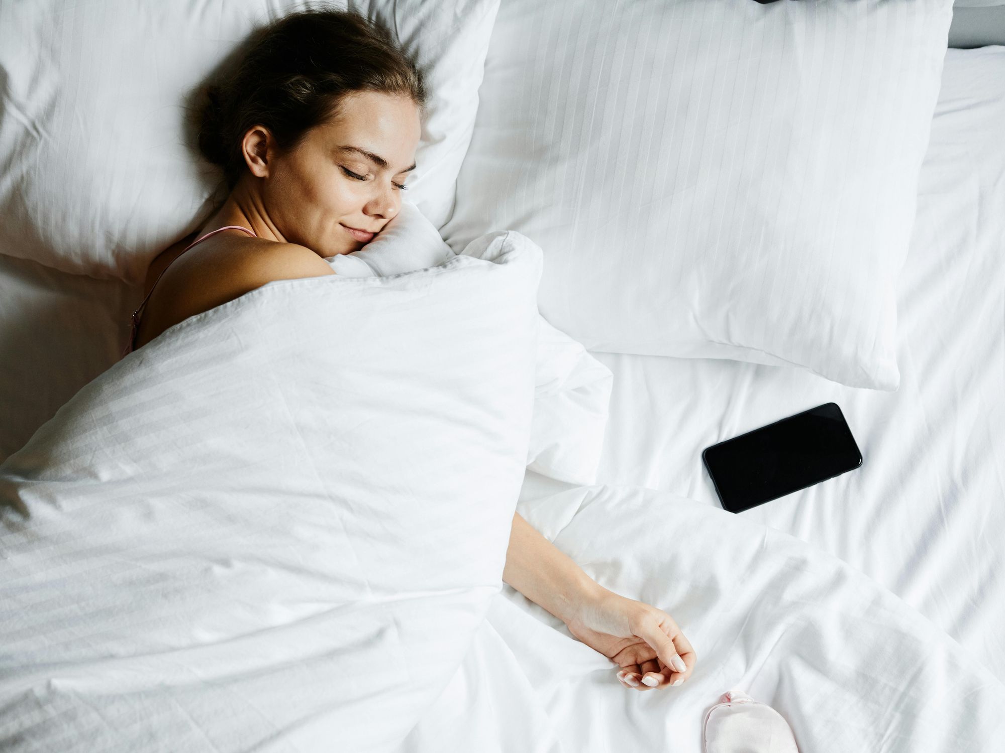 Woman sleeping with duvet