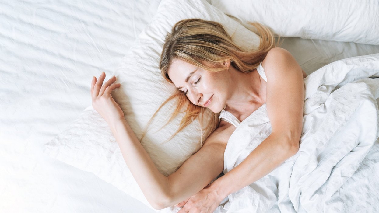 Woman sleeping with duvet