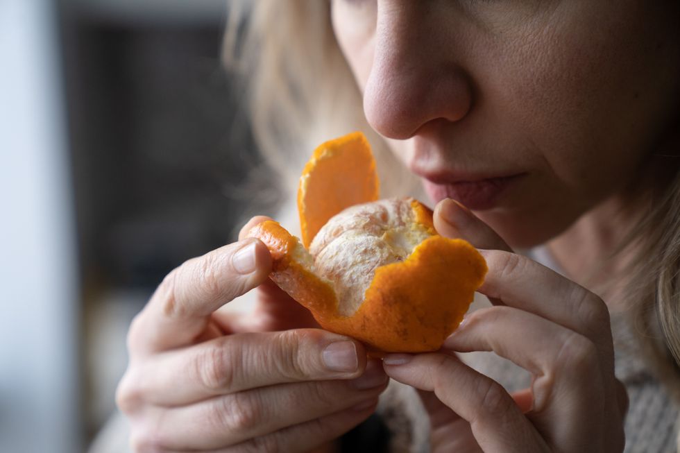 Woman smelling a satsuma